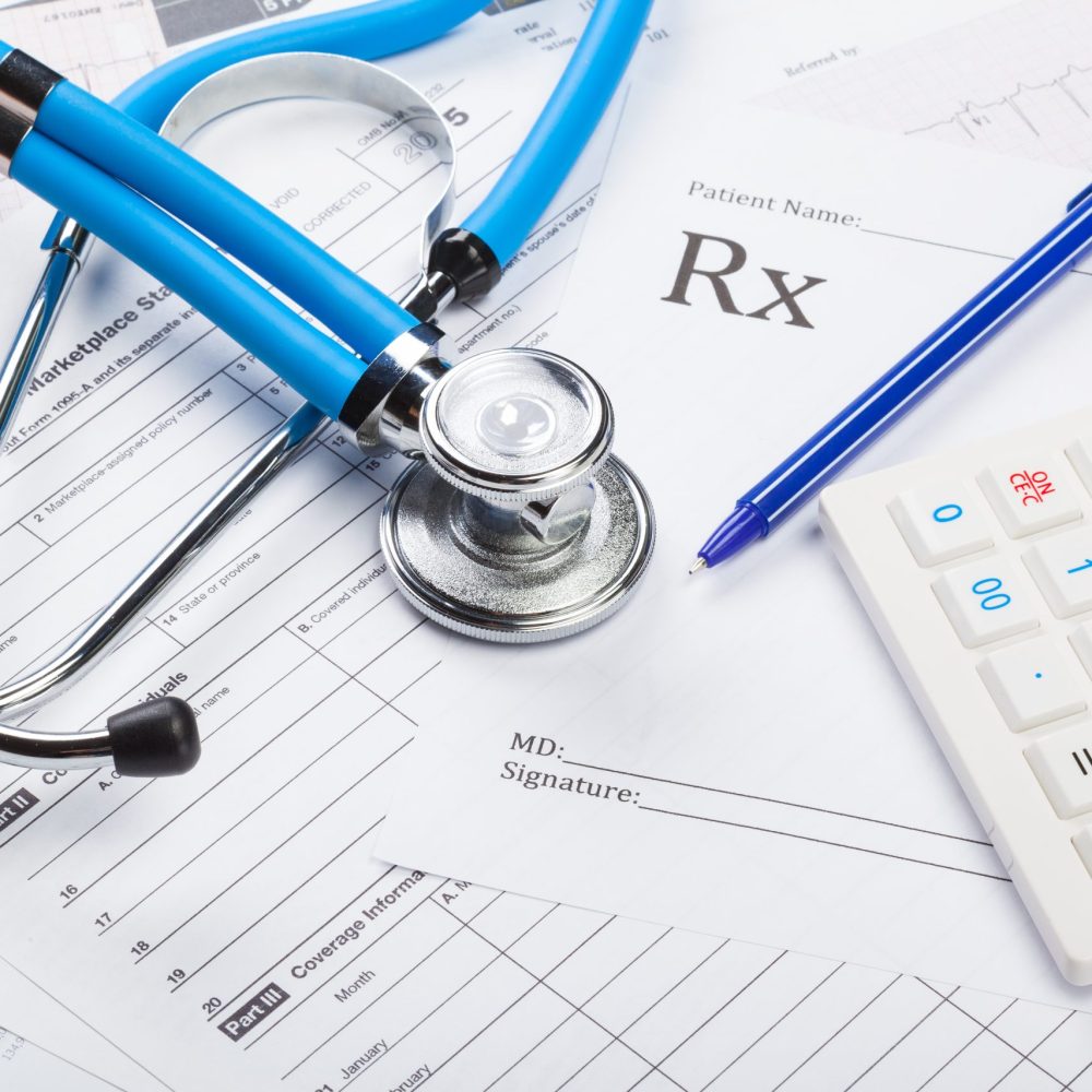 Health care costs. Stethoscope and calculator